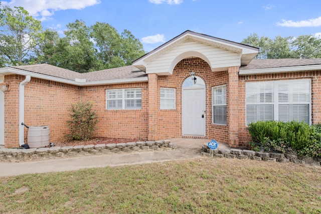 doorway to property featuring a yard