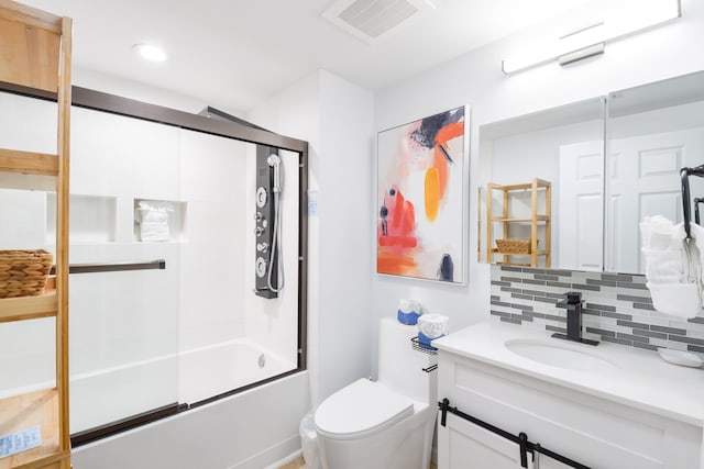 full bathroom with tasteful backsplash, toilet, vanity, and enclosed tub / shower combo