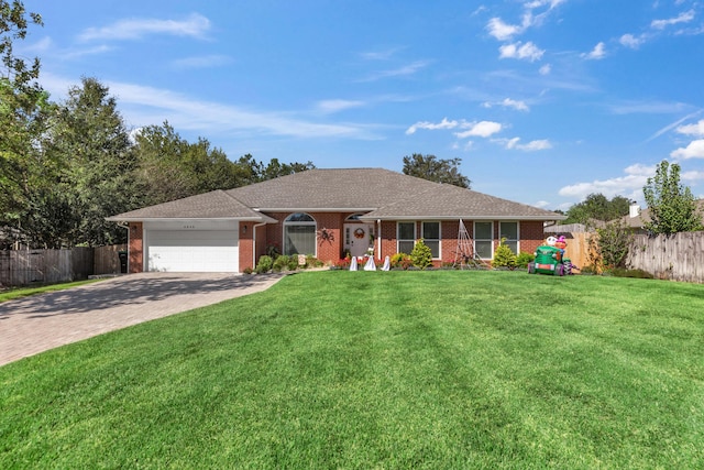 ranch-style home featuring a garage and a front yard