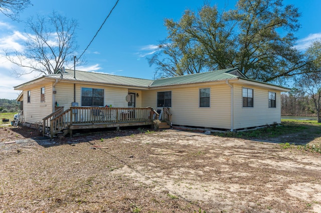 single story home with a wooden deck