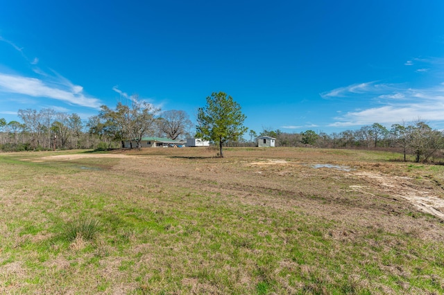 view of yard with a rural view