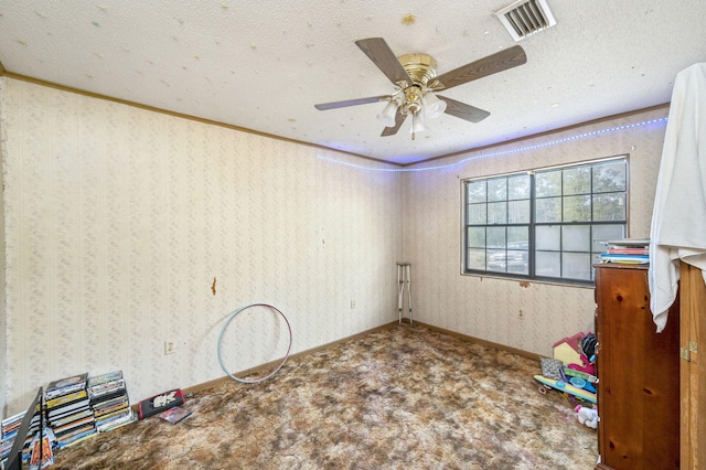 interior space featuring a textured ceiling, ceiling fan, ornamental molding, and carpet flooring