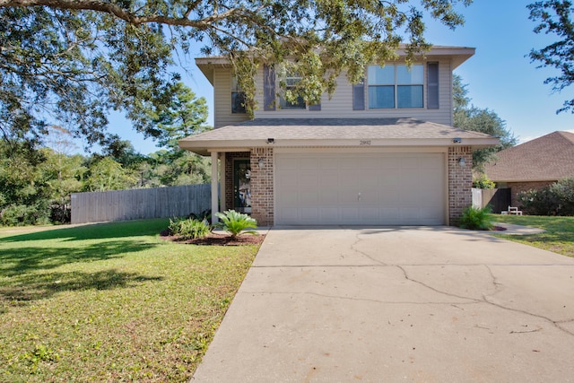 view of front of home featuring a front yard and a garage