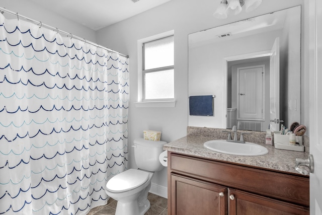 bathroom featuring vanity, toilet, curtained shower, tile patterned floors, and baseboards