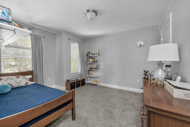 bedroom with carpet flooring and baseboards