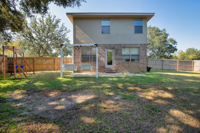 back of property featuring brick siding, a patio, and a playground