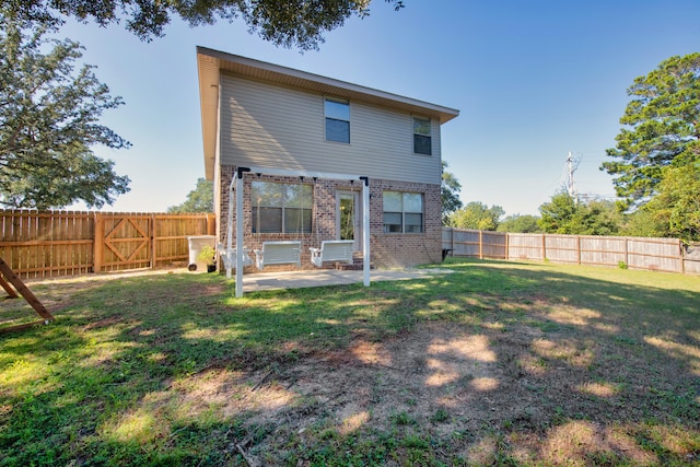 back of house with a lawn and a patio