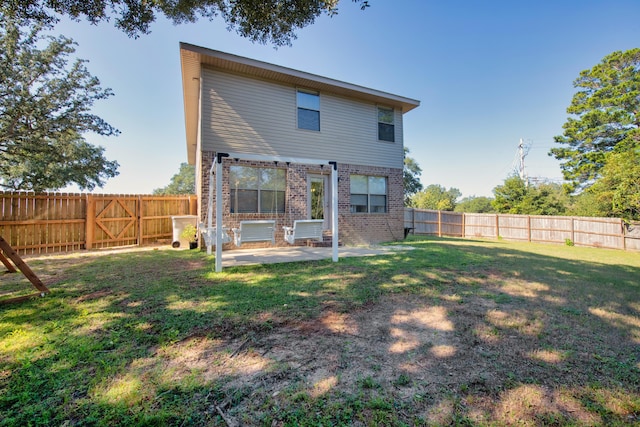 rear view of house with a patio and brick siding