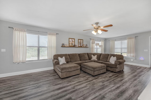living area featuring a ceiling fan, wood finished floors, and baseboards