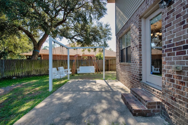 view of patio / terrace featuring a playground and a fenced backyard