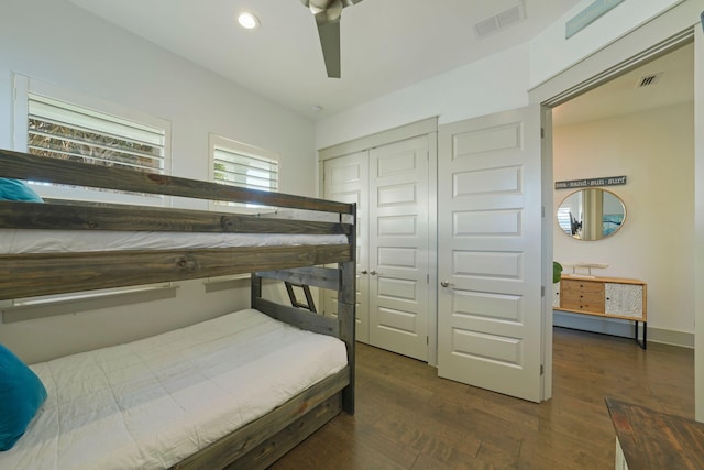 bedroom featuring a closet, dark hardwood / wood-style floors, and ceiling fan