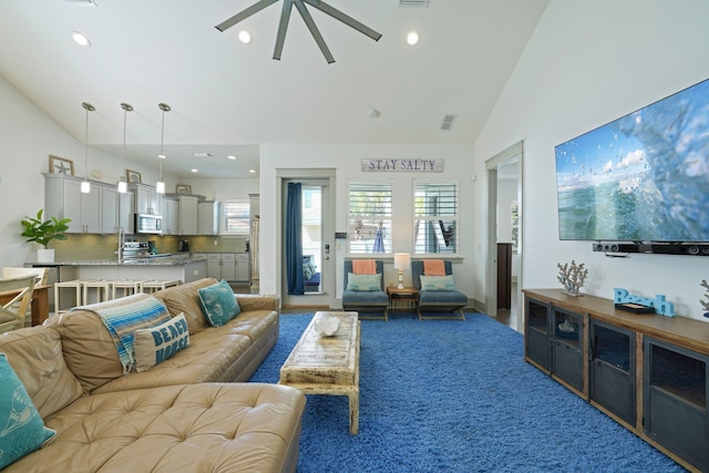 living room with high vaulted ceiling, carpet, and ceiling fan