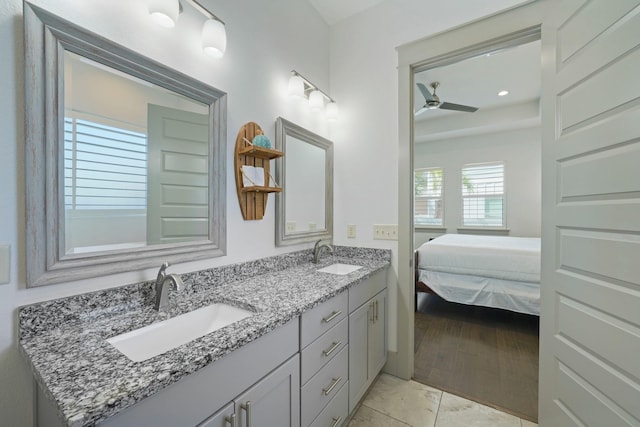 bathroom with ceiling fan, vanity, and wood-type flooring