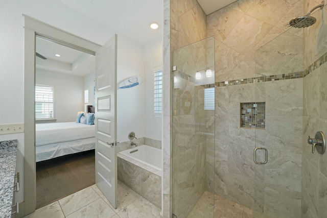 bathroom featuring wood-type flooring and shower with separate bathtub