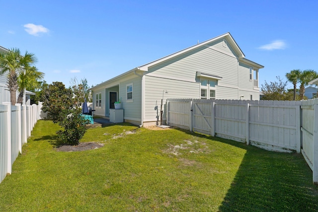 rear view of property featuring a lawn