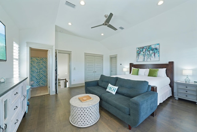 bedroom with two closets, ceiling fan, vaulted ceiling, and dark hardwood / wood-style flooring