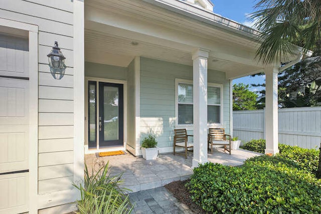 entrance to property with a garage and covered porch