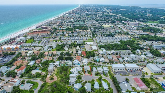 drone / aerial view with a water view and a beach view