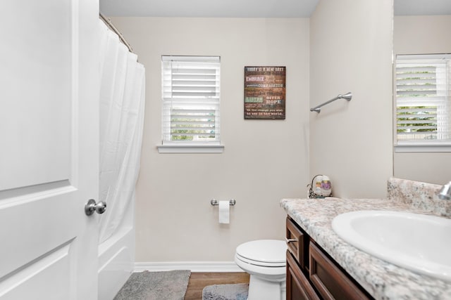 full bathroom featuring vanity, shower / tub combo with curtain, toilet, and hardwood / wood-style flooring