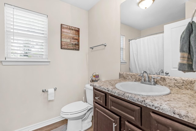 bathroom with vanity, hardwood / wood-style floors, and toilet