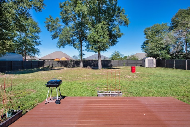 deck with a shed and a lawn