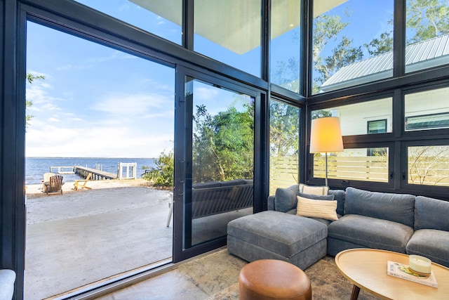 sunroom featuring a water view and a healthy amount of sunlight