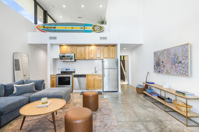 103 Native Tree Ln, Santa Rosa Beach, FL 32459 - living area featuring a high ceiling, concrete flooring, and recessed lighting