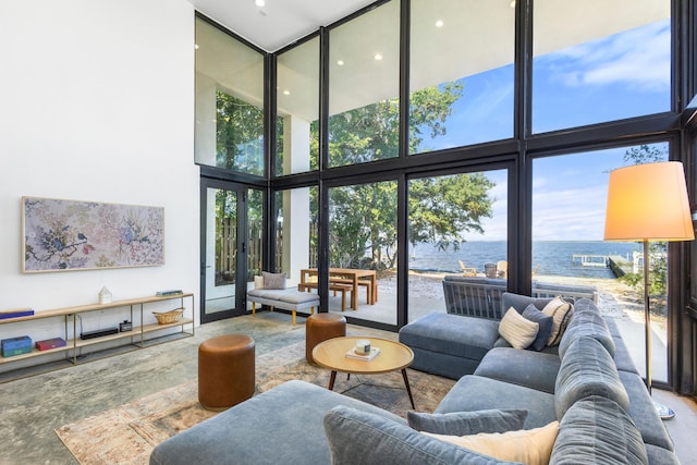 103 Native Tree Ln, Santa Rosa Beach, FL 32459 - living room featuring a water view, a towering ceiling, floor to ceiling windows, recessed lighting, and french doors