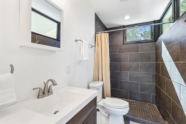 bathroom featuring a shower with shower curtain, vanity, toilet, and tile patterned flooring