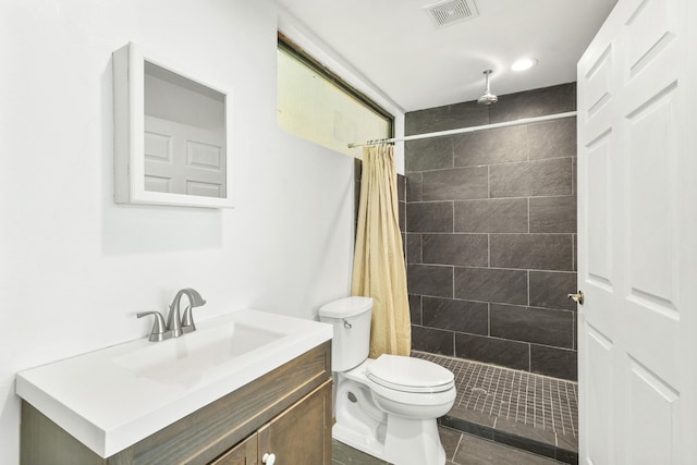 bathroom featuring a shower with curtain, vanity, toilet, and tile patterned floors