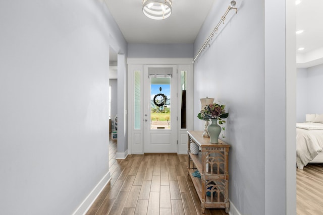 entryway with hardwood / wood-style floors