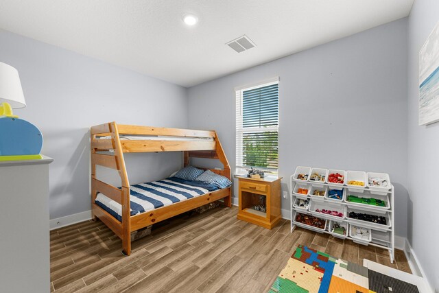 bedroom with wood-type flooring