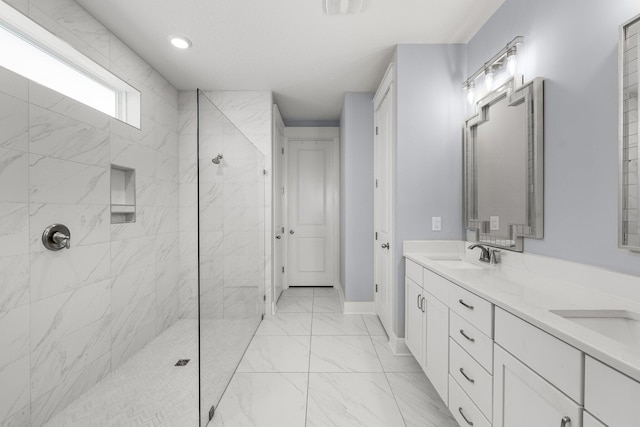 bathroom with vanity and a tile shower