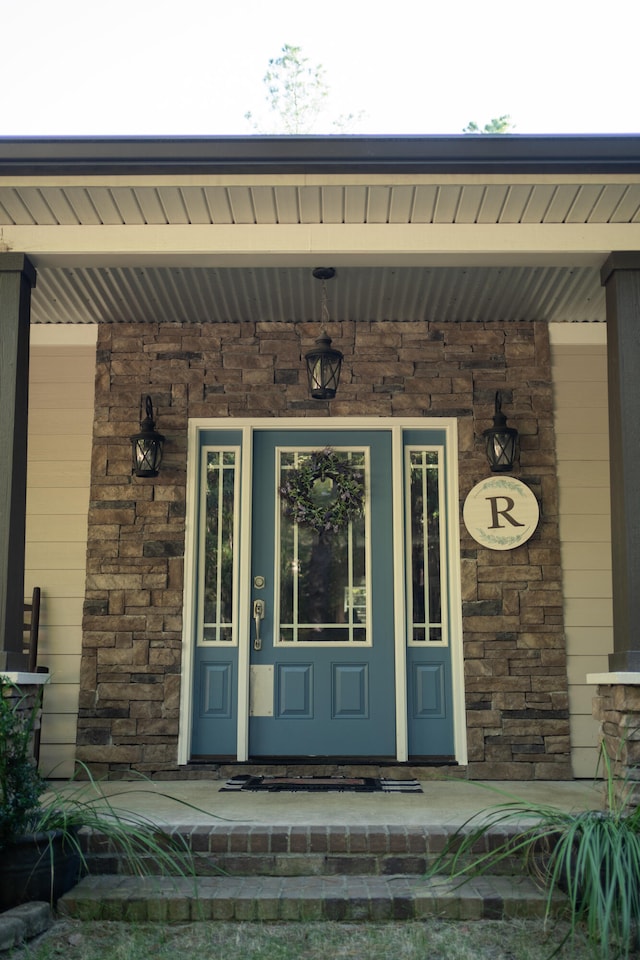 view of exterior entry with covered porch