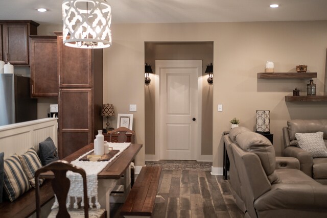 dining room with a notable chandelier and dark hardwood / wood-style floors