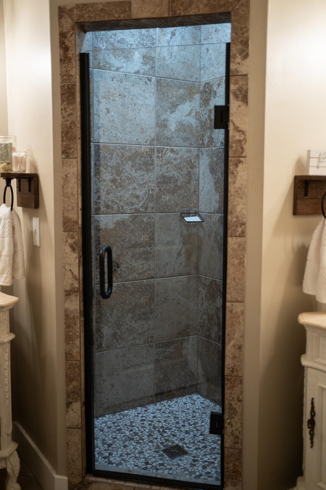 bathroom featuring a shower with door