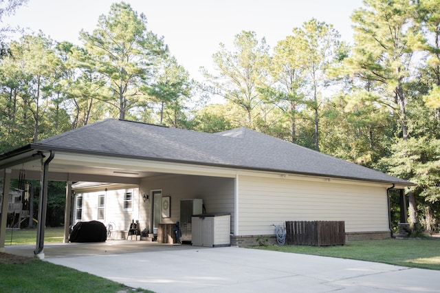 exterior space featuring a yard and a carport