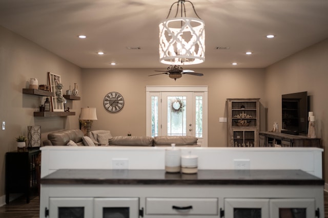 kitchen featuring ceiling fan, decorative light fixtures, hardwood / wood-style floors, and white cabinets