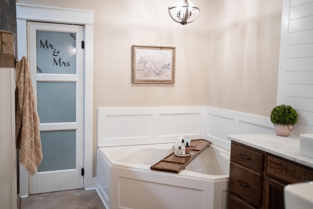 bathroom featuring vanity, a tub, and tile patterned floors