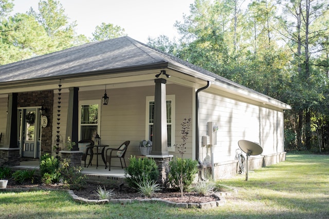 back of property featuring a porch and a lawn