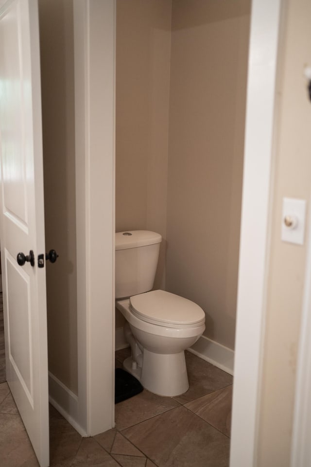 bathroom featuring toilet and tile patterned floors