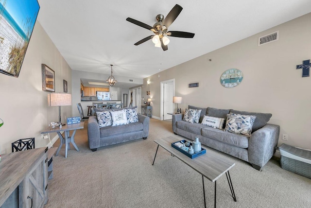 living room featuring light carpet and ceiling fan