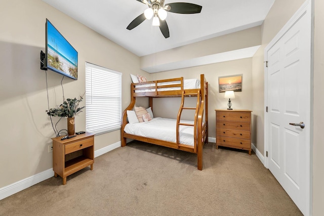 bedroom featuring light colored carpet and ceiling fan