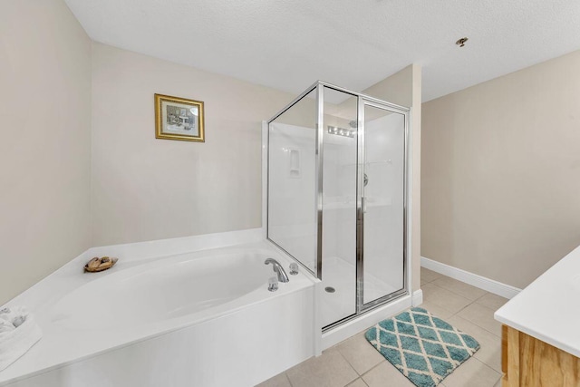 bathroom featuring tile patterned flooring, vanity, plus walk in shower, and a textured ceiling