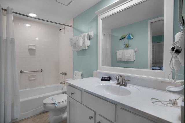 full bathroom with shower / bath combo, vanity, tile patterned flooring, and toilet