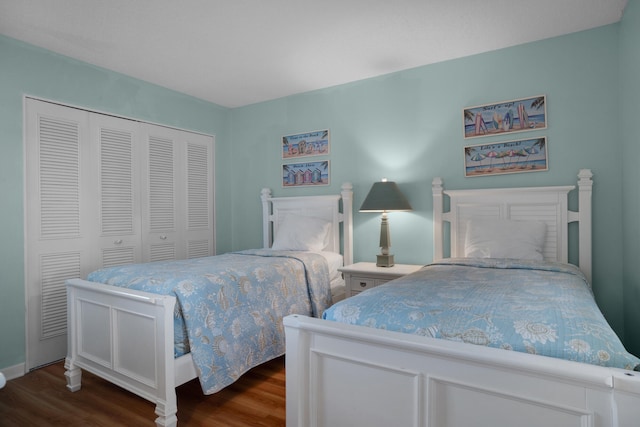 bedroom with a closet and dark hardwood / wood-style flooring