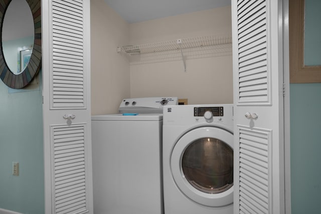 laundry area with washing machine and clothes dryer