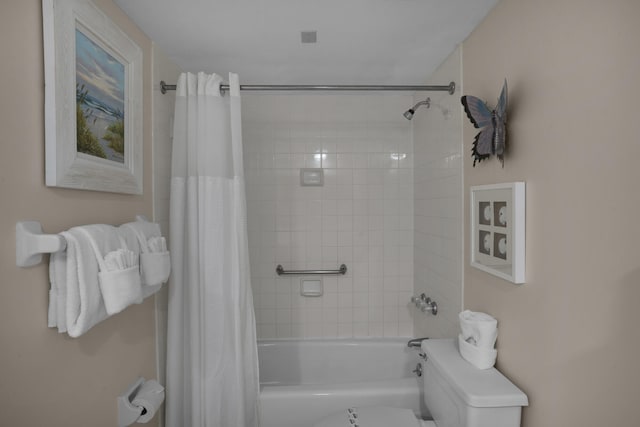 bathroom featuring shower / bath combo and toilet