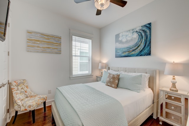 bedroom with ceiling fan and dark hardwood / wood-style flooring