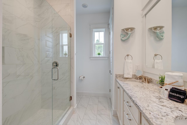 bathroom with walk in shower and vanity